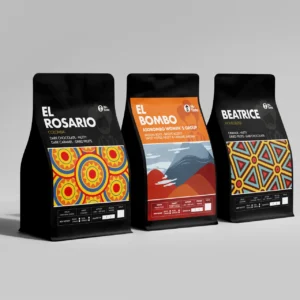 Three Mr. Tinto coffee bags: El Rosario (dark chocolate, nutty), El Bombo (sweet notes, fruity), and Beatrice (orange, nutty), Colombian single-origin coffee blends.